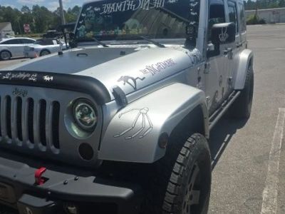 2012 Jeep Wrangler Unlimited Sahara Altitude in Silver — front three-quarter view
