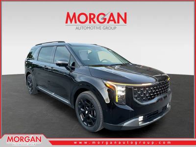 2026 Kia Carnival Hybrid SX in Aurora Black Pearl — front three-quarter view
