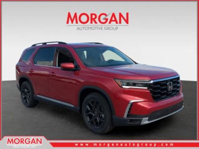 2025 Honda Pilot Touring+ in Radiant Red Metallic II — front three-quarter view