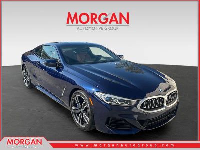2023 BMW 8 Series 840i in Tanzanite Blue II Metallic — front three-quarter view