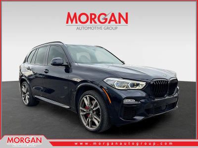 2021 BMW X5 M50i in Carbon Black Metallic — front three-quarter view