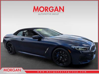 2023 BMW 8 Series 840i in Frozen Tanzanite Blue Metallic — front three-quarter view
