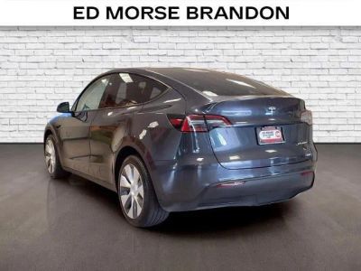 2024 Tesla Model Y — rear three-quarter view