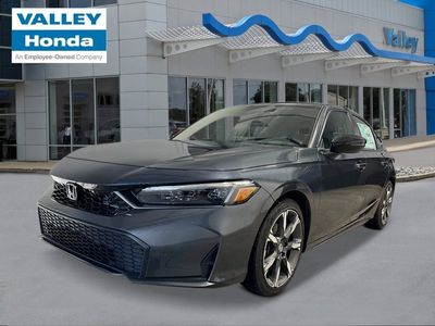 2026 Honda Civic Hatchback Hybrid Sport Touring in Meteorite Gray Metallic — front three-quarter view