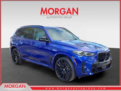 2026 BMW X5 M60i in Marina Bay Blue Metallic — front three-quarter view