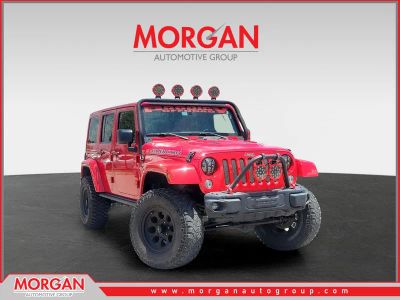 2016 Jeep Wrangler Unlimited Rubicon Hard Rock in Firecracker Red Clearcoat — front three-quarter view