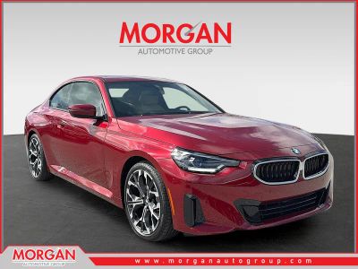 2026 BMW 2 Series 230i in Vegas Red Metallic — front three-quarter view
