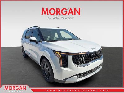 2026 Kia Carnival Hybrid EX in Snow White Pearl — front three-quarter view
