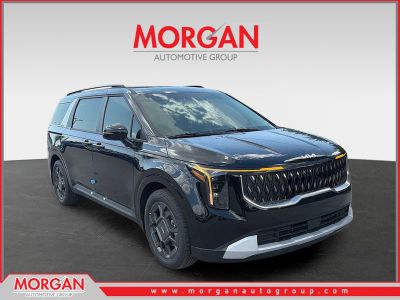 2026 Kia Carnival Hybrid EX in Aurora Black Pearl — front three-quarter view