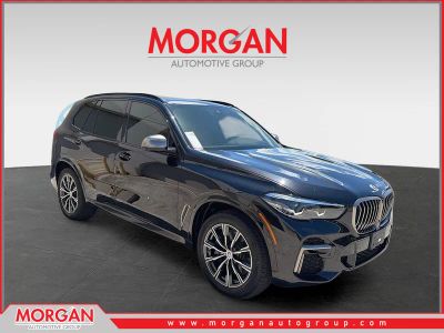 2023 BMW X5 M50i in Black Sapphire Metallic — front three-quarter view