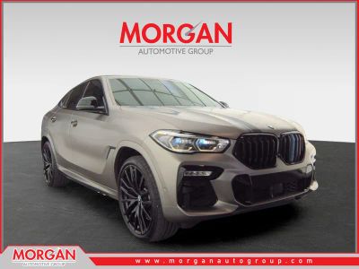 2020 BMW X6 M50i in Tanzanite Blue II Metallic — front three-quarter view