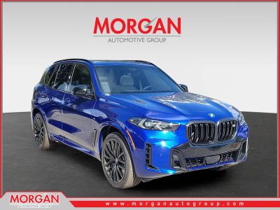 2026 BMW X5 M60i in Marina Bay Blue Metallic — front three-quarter view