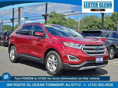 2018 Ford Edge SEL in Ruby Red Metallic Tinted Clearcoat — front three-quarter view