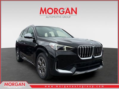 2023 BMW X1 xDrive28i in Jet Black — front three-quarter view