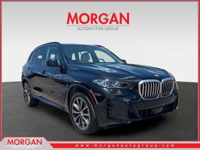 2024 BMW X5 xDrive40i in Black Sapphire Metallic — front three-quarter view
