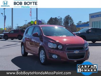 2013 Chevrolet Sonic LT in Crystal Red Tintcoat — front three-quarter view