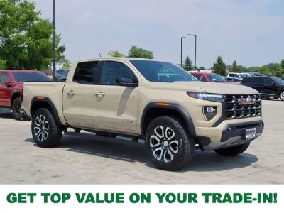2024 GMC Canyon AT4 in Desert Sand Metallic — front three-quarter view