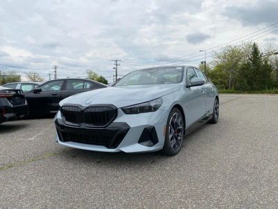 2027 BMW 5 Series 550e xDrive in Brooklyn Grey Metallic — front three-quarter view