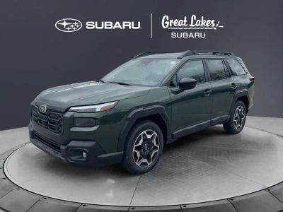 2026 Subaru OUTBACK Touring in Deep Emerald Green Pearl — front three-quarter view