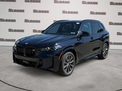 2026 BMW X5 M60i in Carbon Black Metallic — front three-quarter view