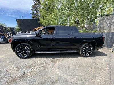 2025 GMC Sierra EV — rear three-quarter view