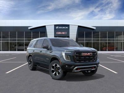 2026 GMC Yukon AT4 Ultimate in Midnight Pine — front three-quarter view