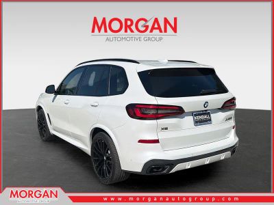 2022 BMW X5 M50i in Mineral White Metallic — front three-quarter view