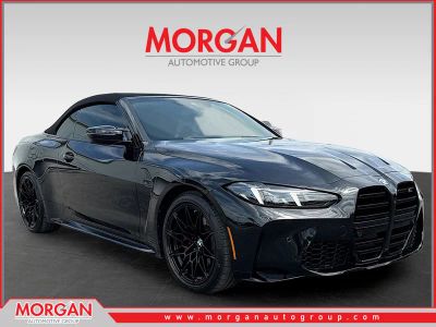 2026 BMW M4 Competition xDrive in Black Sapphire Metallic — front three-quarter view