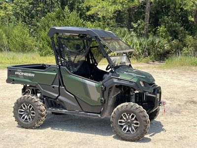 2025 Honda Pioneer 1000 Trail in GRN — front three-quarter view