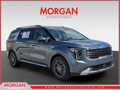 2026 Kia Carnival SX in Astra Blue — front three-quarter view