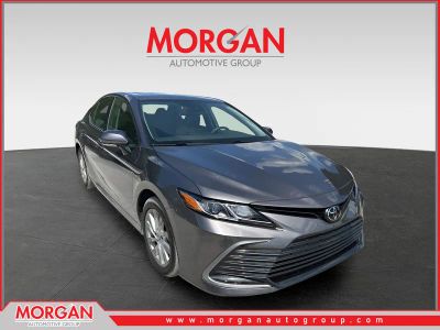2024 Toyota Camry LE in Predawn Gray Mica — front three-quarter view