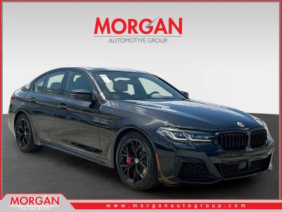 2023 BMW 5 Series M550i xDrive in Black Sapphire Metallic — front three-quarter view