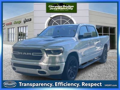 2023 RAM 1500 Laramie Crew Cab 4x4 5'7' Box in Bright White Clearcoat — front three-quarter view