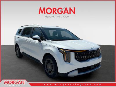 2026 Kia Carnival Hybrid EX in Snow White Pearl — front three-quarter view