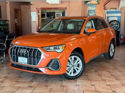 2024 Audi Q3 in Orange — front three-quarter view