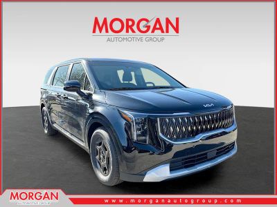 2026 Kia Carnival LXS in Aurora Black Pearl — front three-quarter view