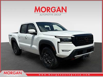 2023 Nissan Frontier PRO-4X in Glacier White — front three-quarter view