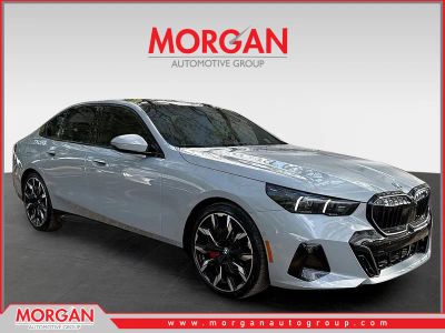 2026 BMW 5 Series 550e xDrive in Brooklyn Grey Metallic — front three-quarter view