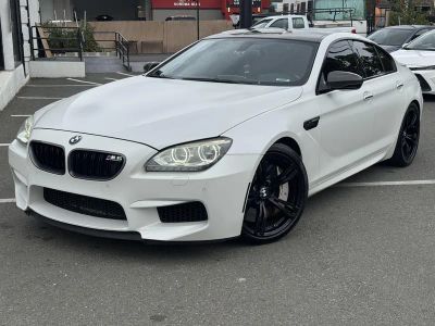 2015 BMW M6 in Frozen White — front three-quarter view