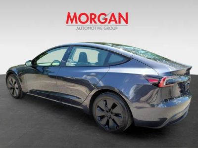 2025 Tesla Model 3 — rear three-quarter view