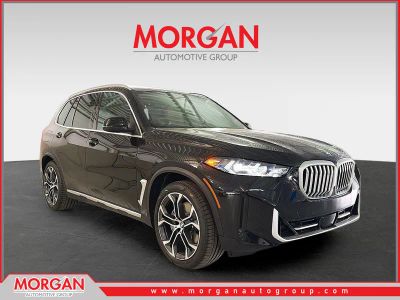 2026 BMW X5 xDrive50e in Black Sapphire Metallic — front three-quarter view