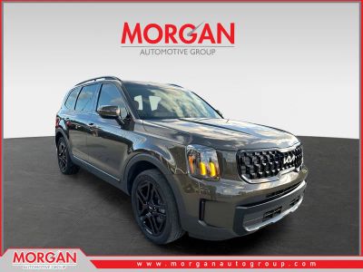 2024 Kia Telluride EX X-Line in Dark Moss — front three-quarter view