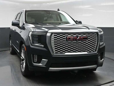 2021 GMC Yukon Denali in Hunter Metallic — front three-quarter view