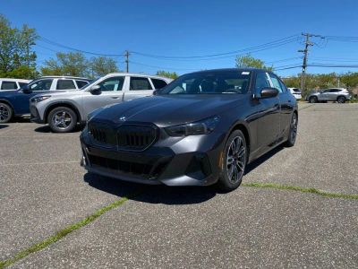 2027 BMW 5 Series 540i xDrive in Dark Graphite Metallic — front three-quarter view