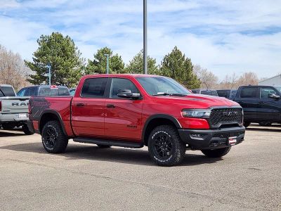 2026 RAM 1500 RAM 1500 REBEL CREW CAB 4X4 5'7' BOX in Molten Red Pearl-Coat Exterior Paint — front three-quarter view