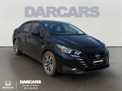2024 Nissan Versa 1.6 SV in Super Black — front three-quarter view
