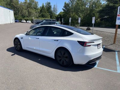 2025 Tesla Model 3 — rear three-quarter view