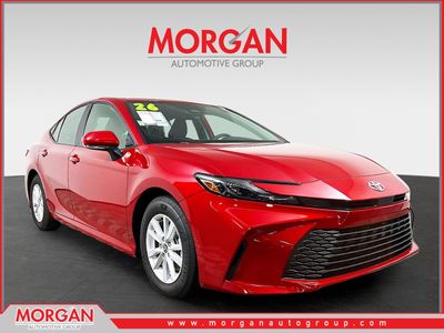 2026 Toyota Camry LE in Red — front three-quarter view