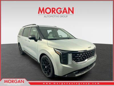 2026 Kia Carnival Hybrid SX in Ivory Silver — front three-quarter view