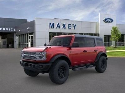 2026 Ford Bronco Badlands® in Ruby Red Metallic Tinted Clearcoat — front three-quarter view